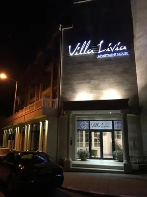 a car parked in front of a building at night at Villa Livia Boutique Apartments in Ravda