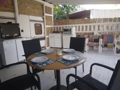 a table and chairs in a kitchen with a table at Camping Goldfish in Sozopol