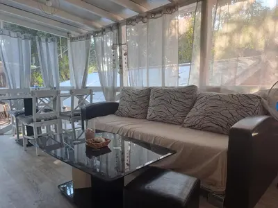 a living room with a couch and a glass table at Camping Goldfish in Sozopol