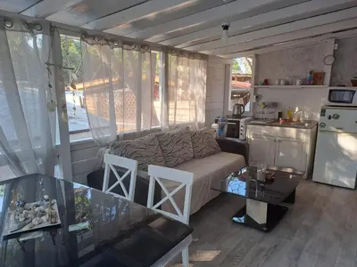 a living room with a couch and a table in a kitchen at Camping Goldfish in Sozopol