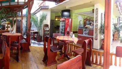 a restaurant with tables and chairs in a room at Guest House Rosa in Kiten