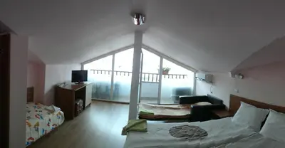 a bedroom with a bed and a cross projected on the wall at Guest House Rosa in Kiten