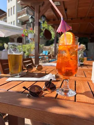 a table with a drink and two glasses on it at Garden of Eden - Studio in Sveti Vlas