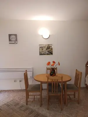 a dining room table and chairs with a vase of flowers on it at Rutland Bay in Ravda