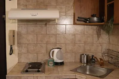 a kitchen counter with a sink and a stove at Cozy Nest Charming Loft in the heart of Varna in Varna City