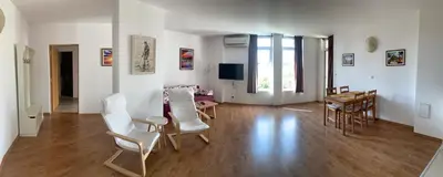 a living room with white chairs and a table at Apolonia Apartments - Boutique Family Residence in Sozopol