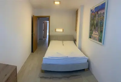 a small bedroom with a bed in a room at Apolonia Apartments - Boutique Family Residence in Sozopol