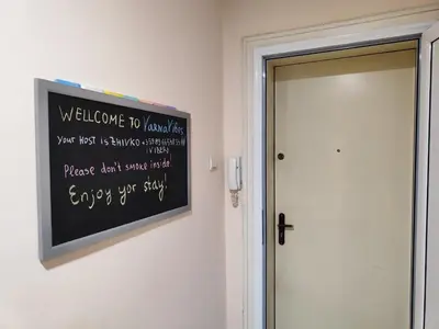 a chalkboard sign on a wall next to a door at Podslon Varna Vibes in Varna City