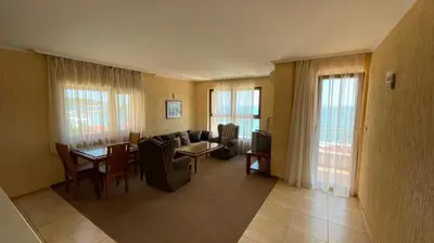 a living room with a couch and a table at Elizabeth Beach Apartments in Nesebar