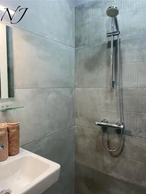 a bathroom with a shower and a sink at NJ Luxury rooms and suites in Varna City