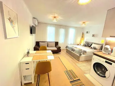 a small living room with a bed and a couch at Studio Aloha in Burgas City