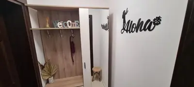a white refrigerator in a room with a wooden cabinet at Studio Aloha in Burgas City