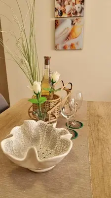 a table with a bowl and a bottle and glasses at Sea Dreams Sunrise Apartment in Sveti Vlas