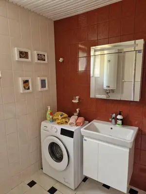a bathroom with a washing machine and a sink at ap Malinov 15 in Varna City