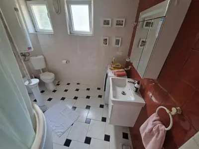 a bathroom with a sink and a shower and a toilet at ap Malinov 15 in Varna City