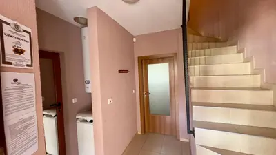 a hallway with a staircase in a building at Guest House Primorsko - Uzundzha in Primorsko