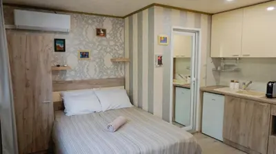 a small room with a bed in a kitchen at Varna Attic Studio - Варна Атик Студио in Varna City