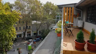 an apartment balcony with potted plants and a courtyard at Varna Attic Studio - Варна Атик Студио in Varna City