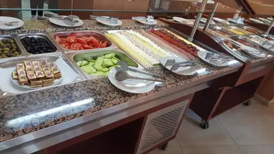 a buffet line with different types of fruits and vegetables at Hotel RIAGOR - ALL INCLUSIVE in Sunny Beach
