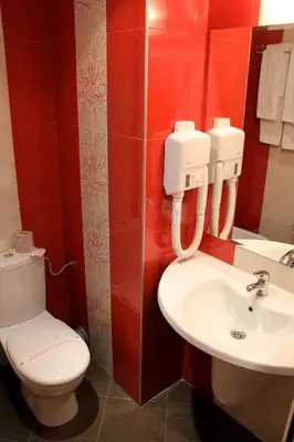 a bathroom with a toilet and a sink at Hotel RIAGOR - ALL INCLUSIVE in Sunny Beach