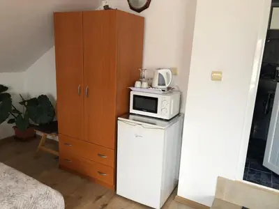 a kitchen with a microwave on top of a refrigerator at Guest House Liliya in Sozopol