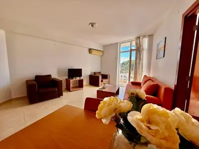 a living room with a couch and a table at Two-bed flat in Sunny Beach with pool view in Sunny Beach