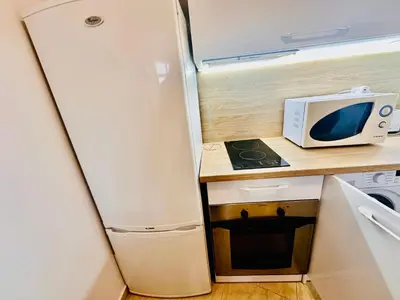 a refrigerator in a kitchen with a microwave at Two-bed flat in Sunny Beach with pool view in Sunny Beach