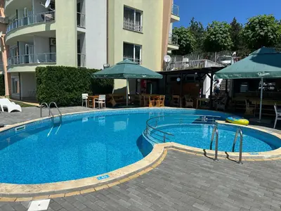 a large swimming pool in front of a building at Alex Beach in Elenite