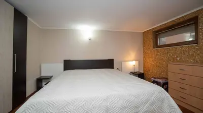a bedroom with a large white bed in it at Paradise Sarafovo Beach in Burgas City