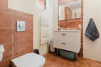 a bathroom with a toilet and a sink and a mirror at Созопол Sozopol- SOZOPOLIS - MORE SUN 2В in Sozopol