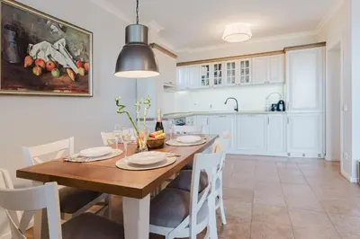 a kitchen and dining room with a wooden table and chairs at Созопол Sozopol- SOZOPOLIS - MORE SUN 2В in Sozopol