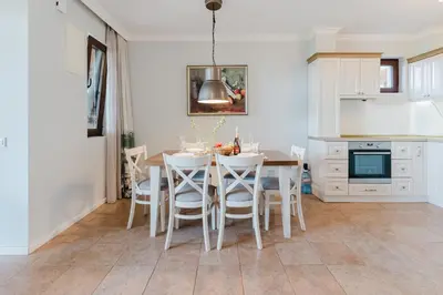 a kitchen with a dining room table and chairs at Созопол Sozopol- SOZOPOLIS - MORE SUN 2В in Sozopol