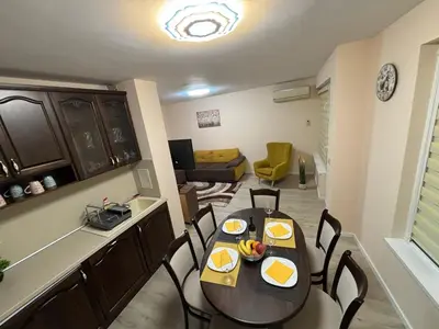a kitchen and dining room with a table and chairs at GRAND APARTMENT BOGORIDI - top center near to sea and sea garden in Burgas City