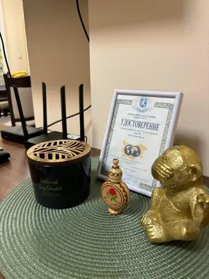a table topped with a gold teddy bear next to a sign at GRAND APARTMENT BOGORIDI - top center near to sea and sea garden in Burgas City