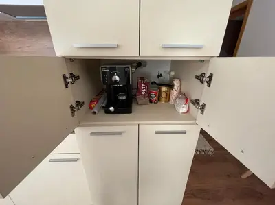 a kitchen with white cabinets and a coffee maker at sunny view cacao beach in Sunny Beach