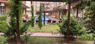 a garden with a pool in the middle of a building at sunny view cacao beach in Sunny Beach
