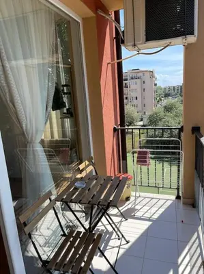 a patio with two chairs and a table on a balcony at sunny view cacao beach in Sunny Beach