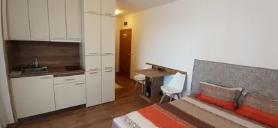 a bedroom with a bed and a kitchen with a desk at sunny view cacao beach in Sunny Beach