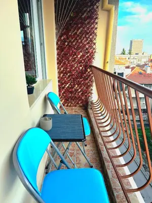 a balcony with a table and chairs on a balcony at Centro apart in Burgas City