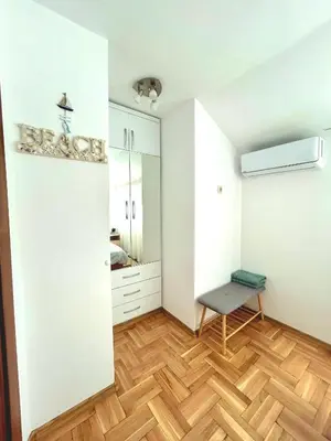 a room with white cabinets and a wooden floor at Centro apart in Burgas City
