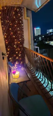 a balcony with a table and a glass of wine at Centro apart in Burgas City