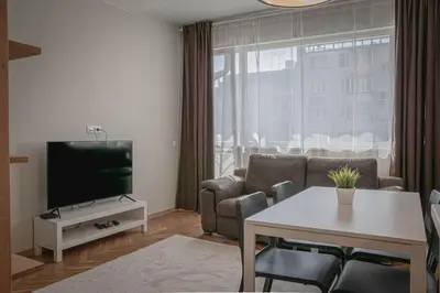 a living room with a couch and a table and a tv at Central Apartment in Varna in Varna City