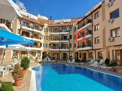 a hotel with a swimming pool in front of a building at Apartment Oasis A4 Kamchia in Bliznatsi