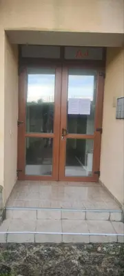 an entrance to a building with two glass doors at Apartment Oasis A4 Kamchia in Bliznatsi