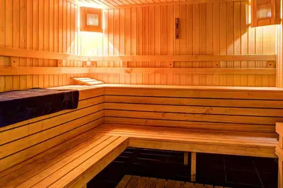 a wooden sauna with a bench in the middle at Paradise Apartments Primorsko in Primorsko