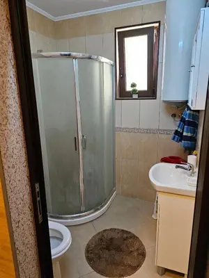 a bathroom with a shower and a toilet and a sink at Apartament Marinela 2 in Pomorie