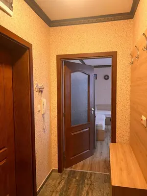 a hallway with a door and a room with a bed at Apartament Marinela 2 in Pomorie