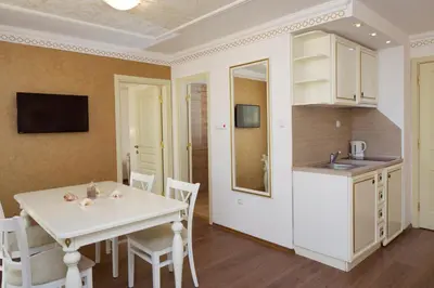 a kitchen and dining room with a white table and chairs at Hotel Golden Ina - All Inclusive - Beachfront in Sunny Beach