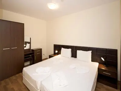a bedroom with a large white bed with white sheets at Hotel Golden Ina - All Inclusive - Beachfront in Sunny Beach