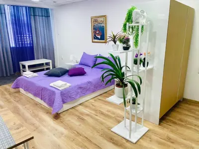 a bedroom with a purple bed with purple pillows at Studio 21 in Varna City